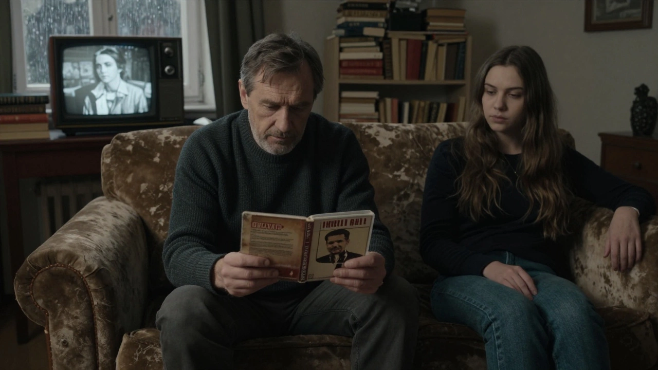 A man and woman sit silently together in a dim room, watching an old film, no words needed.